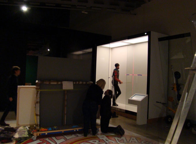 Collections Team assisting Chris to install the two posters (Credit: TOSM)