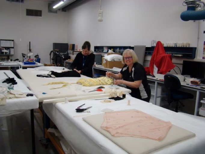 Sam (L) and Claire mounting the swim wear onto a prepared board for display. Sam (L) and Claire mounting the swim wear onto a prepared board for display.